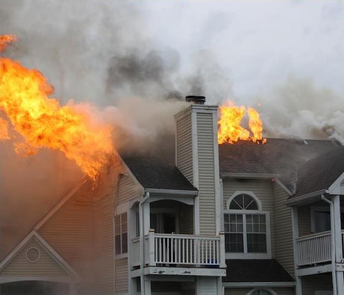  img src =”fire” alt = " residential home with roof caught on fire ” >