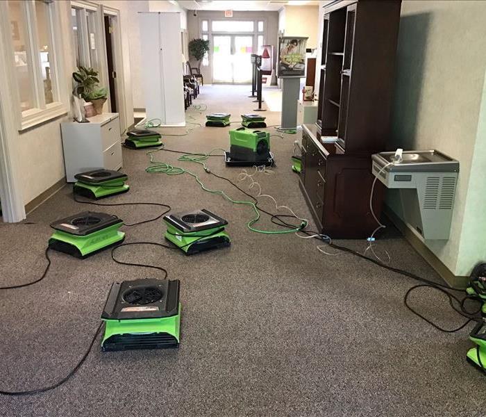 Wet carpet in a local business from water intrusion caused by rain and storms with drying equipment placed. 
